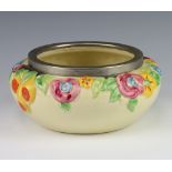 A Clarice Cliff moulded bowl decorated with flowers with a metal rim no.993, 22cm