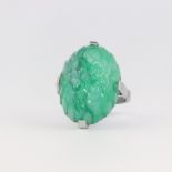 An Art Deco white metal carved hardstone oval green stone cocktail ring 7.8 grams, size N