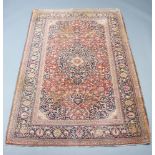 A North West Persian red and blue ground rug with central medallion within a multi row border