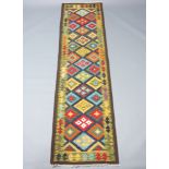 A black, blue and brown ground Maimana Kilim runner with overall diamond design 302cm x 82cm