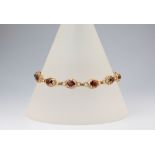 An 18ct yellow gold ruby set bracelet 10.8 grams