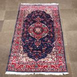 A North West Persian blue and red ground carpet with central medallion 252cm x 150cm