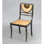A Regency style black and gilt painted bedroom chair with woven cane seat and back, raised on