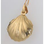 A yellow metal stamped 750 shell shaped locket on an 18ct chain, the chain 4.6 grams 49cm, the