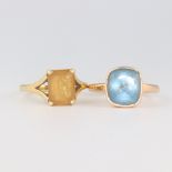 An 18ct yellow gold citrine ring size M 1/2, a yellow metal topaz ring size M 1/2, gross weight 9