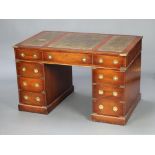 A military style pedestal desk with green inset leather writing surface above 1 long and 8 short