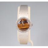 A lady's Omega white metal stamped 18k wristwatch with tigers eye dial and 28 brilliant cut diamonds