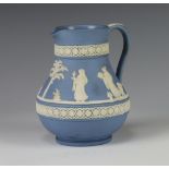 A Wedgwood blue Jasper jug decorated with band of classical figures 14cm