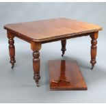 A Victorian mahogany extending dining table raised on turned and reeded supports with 1 extra leaf