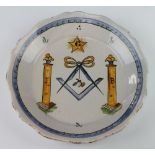 A 19th Century Delft plate decorated with Masonic symbols 23cm diam.