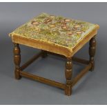 A 1930's, 17th Century style square beech framed stool with Berlin woolwork seat decorated a tree