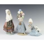 A Lladro figure of a seated girl with kitten and puppy 17cm, a ditto of a Spanish girl 27cm and a