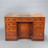 A Victorian mahogany pedestal dressing table fitted 1 long and 8 short drawers with tore handles,