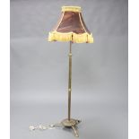 A 19th Century adjustable brass standard lamp raised on shaped base 124cm h
