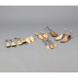 A pair of 19th Century beech folding shoe trees and 12 other wooden shoe trees