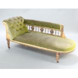 A Victorian carved oak showframe chaise longue with bobbin turned decoration, upholstered in