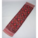 A red ground Meshwani runner with 14 diamonds to the centre 247cm x 63cm The rug does not sit flat