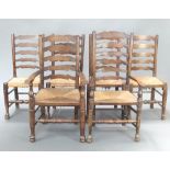 A 20th Century harlequin set of 6 elm ladder back dining chairs with woven rush seats, raised on