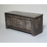 An 18th Century oak coffer of panelled construction with hinged lid and iron butterfly hinges 49cm h
