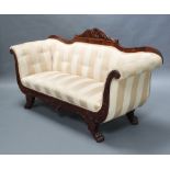 A William IV carved mahogany show frame sofa upholstered in yellow striped material raised on shaped