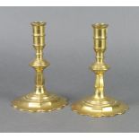 A pair of 17th/18th Century polished brass petal base candlesticks 16cm h x 10cmOne stick has a very