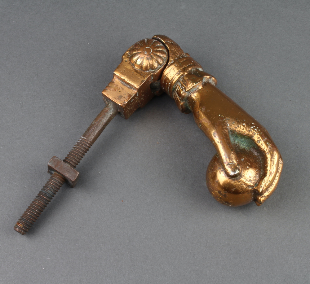 A 19th Century coppered door knocker in the form of a ladies hand clasping a ball 13cm x 4cm x 5cm