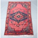 A red and blue ground Afghan rug with diamond shaped medallion to the centre 230cm x 150cm Some