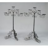 A pair of wrought iron 5 light candelabrum raised on shaped feet 116cm h x 73cm w the base 60cm d