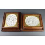 A pair of Victorian plaster relief plaques of birds contained in oak cushion shaped frames, one with
