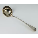 A George III silver Old English pattern ladle with bright cut decoration and crest London 1806,