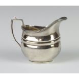 A silver cream jug of Georgian design Birmingham 1929, 9cm, 92 grams
