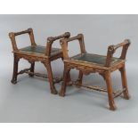 A pair of Victorian ecclesiastical carved mahogany organ stools raised on outswept supports with H