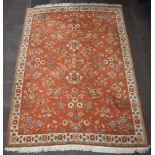 A 1930's peach and floral patterned machine made carpet 334cm x 242cm Small section of fringe to the