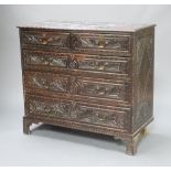 An 18th/19th Century carved oak chest of 2 short and 3 long drawers, raised on bracket feet 98cm h x