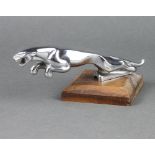 A Jaguar car mascot mounted on a wooden stand 20cm x 3cm, base marked 710091/1 Web