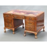 A Queen Anne style mahogany inverted breakfront pedestal desk with inset leather writing surface,