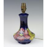 A Moorcroft baluster table lamp, with blue ground decorated flowers 18cm