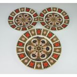 A Royal Crown Derby Imari pattern plate 27cm, a pair of ditto 22cm
