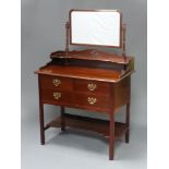 An Edwardian Chippendale style mahogany dressing table, the back with arched bevelled plate mirror