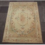 An Aubusson style cream ground and floral patterned machine made rug 239cm x 170cm