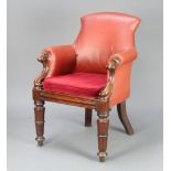 A William IV mahogany show frame armchair upholstered in red material, raised on turned supports
