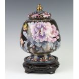 A 20th Century Chinese cloisonne enamelled urn and cover of baluster form decorated birds, raised on