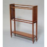 An Edwardian mahogany towel rail the base with undertier, raised on shaped supports 93cm x 76cm x
