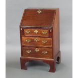 A Georgian mahogany bureau with fall front and well fitted interior above 3 long drawers, raised