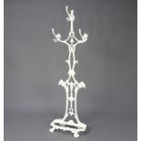 A Victorian white painted cast iron umbrella stand of tracery form with 3 coat hooks, the reverse
