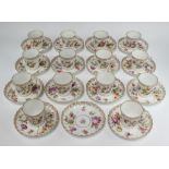 A set of 14 Dresden cups and saucers decorated with spring flowers Five cups are damaged, 1 saucer