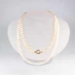 A cultured pearl necklace with a 9ct yellow gold clasp together with a freshwater cultured ditto and