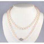 A strand of 106 cultured pearls each approx. 6mm with a white metal stamped 585 diamond set ball