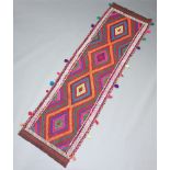 An orange, red and tanned ground Suzni runner with 4 diamonds to the centre 263cm x 75cm