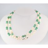 A cultured pearl and green hardstone bead necklace 76cm, with silver clasp